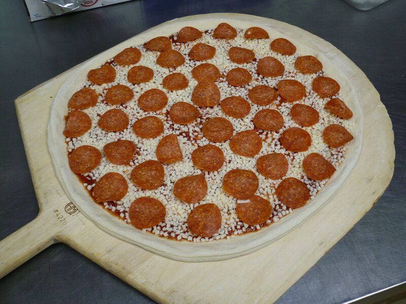 Abo's pepperoni pizza on the peel, ready for the deck oven